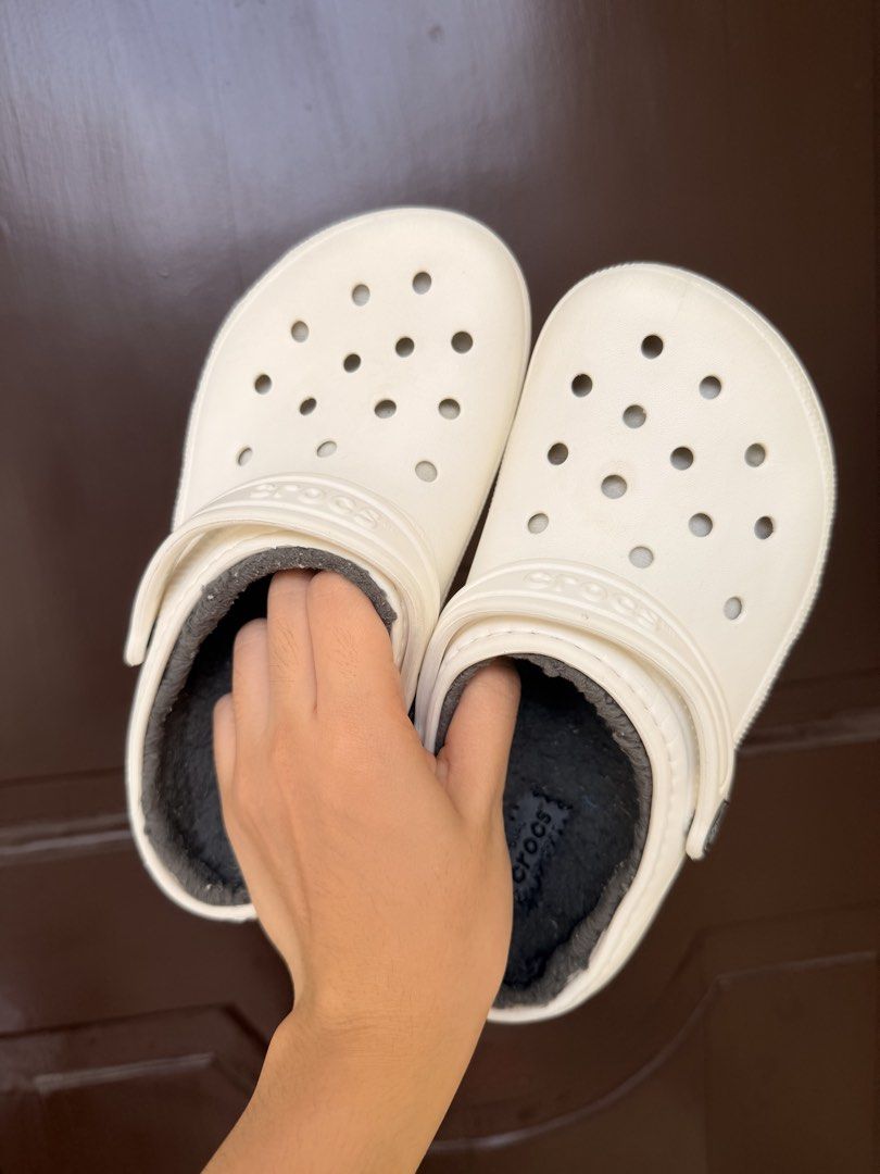 Crocs Classic White C13 (Dual Crocs Comfort) (Category: Babies & Kids Fashion) located in Manila. Submitted by dashcash (Listing ID 1466817230, Image 1). Description: - Authentic White Crocs clogs with cozy grey fuzzy lining - Size: C13 - Features: Slip-on design, ventilation holes, and pivoting heel straps - Soles: Sturdy traction treads with Crocs branding - Condition: Clean white outer material with no major scuffs.