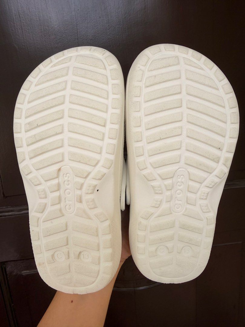 Crocs Classic White C13 (Dual Crocs Comfort) (Category: Babies & Kids Fashion) located in Manila. Submitted by dashcash (Listing ID 1466817230, Image 2). Description: - Authentic White Crocs clogs with cozy grey fuzzy lining - Size: C13 - Features: Slip-on design, ventilation holes, and pivoting heel straps - Soles: Sturdy traction treads with Crocs branding - Condition: Clean white outer material with no major scuffs.