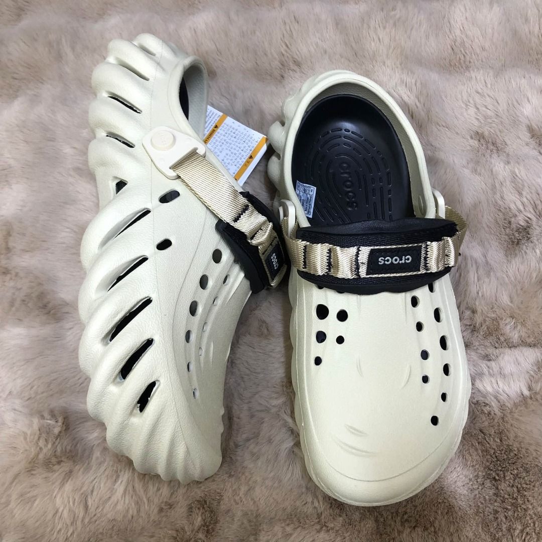 Crocs Echo Clog Multiple Colors Available (Category: Slippers & Slides) located in Manila. Submitted by khielnatha93179 (Listing ID 1466789926, Image 3). Description: Crocs Echo Clogs, multiple colorways available including grey, black, cream, and brown. Unique sculpted design with ventilation holes. Adjustable nylon strap across the top with Crocs branding patch. Lightweight molded Croslite construction. Chunky futuristic aesthetic. Tags attache