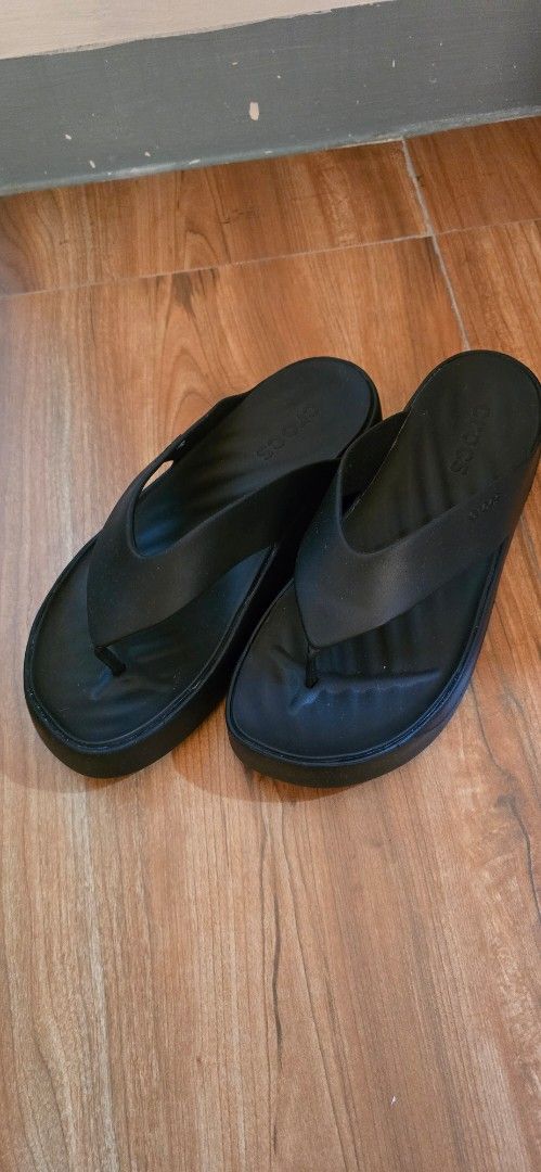Crocs Platform Thong Sandals Black Size W10 (Category: Slippers and slides) located in Marikina City. Submitted by jona.jah (Listing ID 1466776246, Image 3). Description: - Brand: Crocs - Style: Platform thong sandals / wedge - Size: Women's US 10 - Color: Black - Features: Thick wedge sole, classic thong strap, textured footbed for extra grip - Condition: Clean undersoles with plenty of tread left - Perfect for: Casual, everyday warm-weather wea