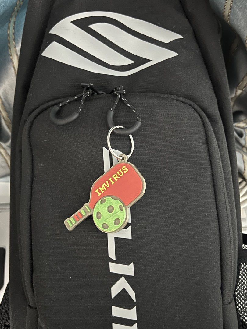 Custom 3D Printed Pickleball Paddle Bag Tag Keychain Name (Category: Racket and Ball Sports) located in Marikina City. Submitted by johnurbina (Listing ID 1466902897, Image 2). Description: Custom 3D printed pickleball paddle keychain. Includes metal split ring for hanging on bags or keys. Shows names like Ding, Myr, Edna, Susan, JR, Lu R., and IMVIRUS in bright lettering with a matching pickleball graphic. Great way to personalize sports gear an