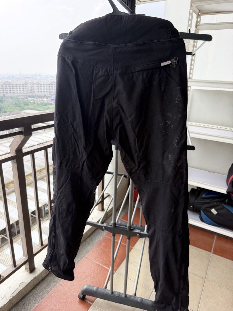 Dainese Black Motorcycle Riding Pants (Category: Jeans) located in Taguig. Submitted by JBT1968 (Listing ID 1466927811, Image 2). Description: - Brand: Dainese - Color: Classic Black - Protection: Built-in protective panels at the knees with logo patches - Fit & Features: Adjustable waist straps, standard zip fly, button closure, and practical pockets - Condition: Pre-owned with visible signs of use and marks on the fabric, particularly on the ba