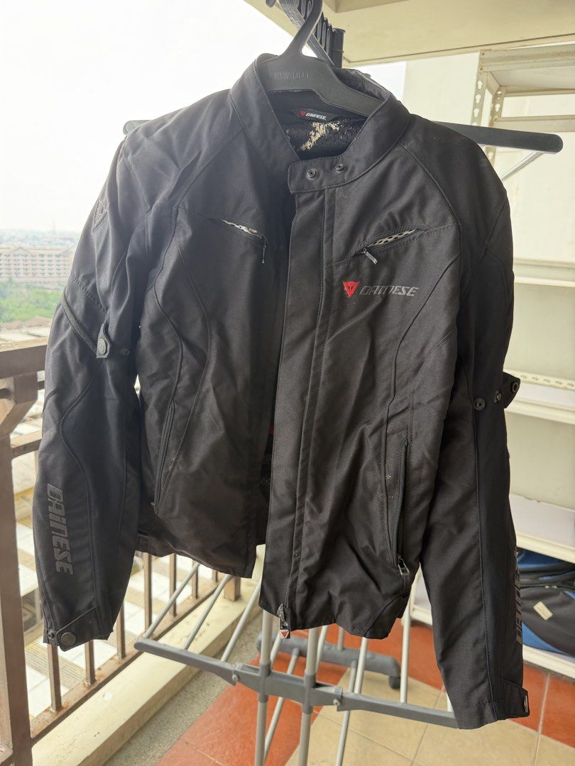 Dainese Black Textile Motorcycle Jacket Size 40 (Category: Coats, Jackets and Outerwear) located in Taguig. Submitted by JBT1968 (Listing ID 1466927483, Image 1). Description: - Authentic Dainese textile motorcycle jacket in Black - Size: 40 (Made in Armenia) - Full zip front with red Dainese logo embroidery on chest - Large reflective demon logo patch on the back for night visibility - Multiple zipper vents on front and arms for airflow - Adjust