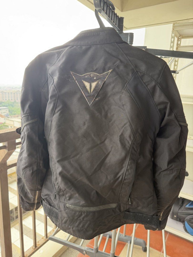 Dainese Black Textile Motorcycle Jacket Size 40 (Category: Coats, Jackets and Outerwear) located in Taguig. Submitted by JBT1968 (Listing ID 1466927483, Image 2). Description: - Authentic Dainese textile motorcycle jacket in Black - Size: 40 (Made in Armenia) - Full zip front with red Dainese logo embroidery on chest - Large reflective demon logo patch on the back for night visibility - Multiple zipper vents on front and arms for airflow - Adjust