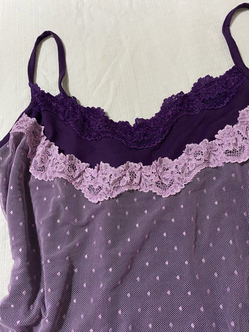 Dazy Purple Lace Trim Dot Mesh Cami Size M (Category: Sleeveless) located in Quezon City. Submitted by getitrightaway.ph (Listing ID 1466847824, Image 2). Description: - Brand: Dazy - Size: Medium (tag on collar) - Color: Purple with light lavender accents - Design: Mesh overlay with all-over polka dots, dark purple lace neckline, and light lavender lace ruffle - Features: Adjustable thin shoulder straps, smooth solid purple back, and stretchy ma