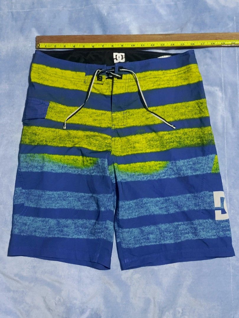 DC Board Shorts Titanium M Blue Yellow Size 32 (Category: Swim Trunks & Board Shorts) located in City of Isabela. Submitted by warmbird.d06e6f (Listing ID 1466885301, Image 1). Description: - Brand/Model: DC Titanium Board Shorts - Color: Blue and lime green striped pattern - Size: 32 - Material: 86% polyester, 14% spandex (flexible and quick-dry) - Features: Drawstring waist, back pocket with velcro flap, DC logo on the leg - Origin: Made in Chi