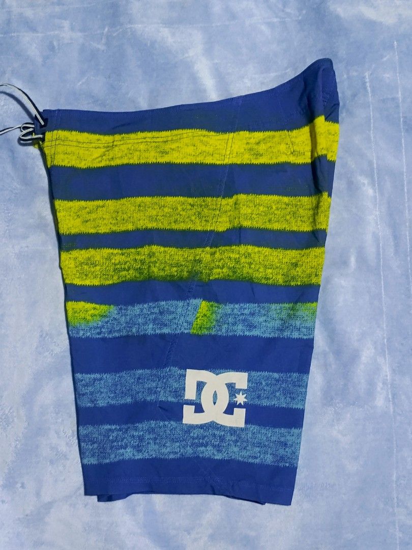 DC Board Shorts Titanium M Blue Yellow Size 32 (Category: Swim Trunks & Board Shorts) located in City of Isabela. Submitted by warmbird.d06e6f (Listing ID 1466885301, Image 2). Description: - Brand/Model: DC Titanium Board Shorts - Color: Blue and lime green striped pattern - Size: 32 - Material: 86% polyester, 14% spandex (flexible and quick-dry) - Features: Drawstring waist, back pocket with velcro flap, DC logo on the leg - Origin: Made in Chi