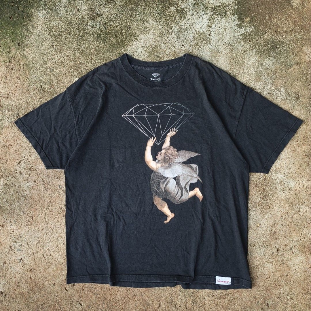 Diamond Supply Co. Cherub Shirt (Category: Tshirts & Polo Shirts ) located in Laguindingan. Submitted by lootsbyberle (Listing ID 1466790984, Image 1). Description: 25.5x29 XXL on Tag Diamond Supply Co. OPT 🔥 Has pinhole near the print (check photo) Trendy Streetwear design, perfect for skaters💎 MOP: GCASH NO COD, NO FREE SHIP POLICY.