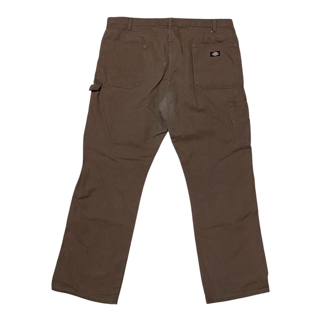 Dickies Brown Duck Canvas Carpenter Pants (Category: Chinos) located in Binan City. Submitted by doze16 (Listing ID 1466865543, Image 1). Description: - Brand: Dickies - Style: Classic carpenter pants / utility wear - Material: Sturdy brown duck canvas cotton - Features: Side tool pockets, hammer loop, and signature back pocket logo patch - Condition: Good overall with a small spot of wear on the upper back near the yoke seam - Perfect for daily 