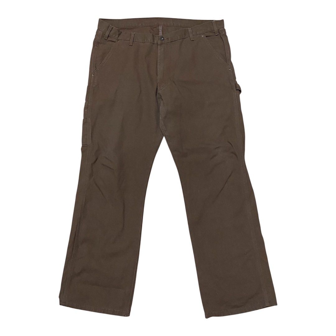 Dickies Brown Duck Canvas Carpenter Pants (Category: Chinos) located in Binan City. Submitted by doze16 (Listing ID 1466865543, Image 3). Description: - Brand: Dickies - Style: Classic carpenter pants / utility wear - Material: Sturdy brown duck canvas cotton - Features: Side tool pockets, hammer loop, and signature back pocket logo patch - Condition: Good overall with a small spot of wear on the upper back near the yoke seam - Perfect for daily 
