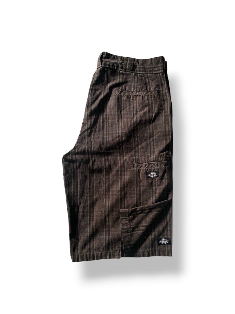 Dickies Regular Fit Pinstripe Shorts Brown (Category: Shorts) located in Mendez-Nunez. Submitted by leighthrift (Listing ID 1466890876, Image 1). Description: DICKIES BROWN PLAID DIMES: WAIST: 36 LENGTH: 24 THIGH: 14 HEM: 12 ISSUE: MINI SCRATCH - Brand: Dickies - Color: Brown with subtle vertical pinstripes - Fit: Regular fit - Details: Multiple utility pockets, signature logo patches on pocket flaps - Closure: Button closure with zip fly - Mater