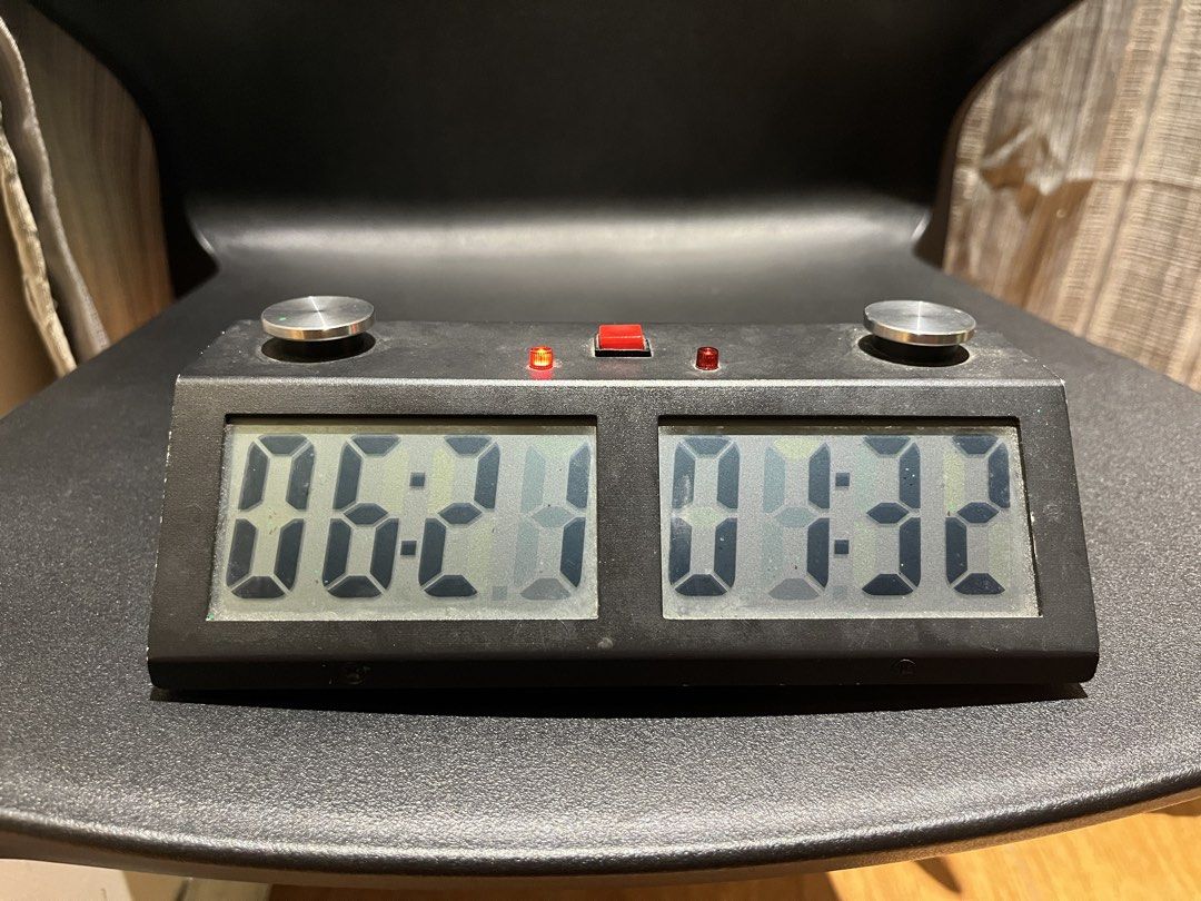 Digital Chess Clock Timer for Board Games (Category: Board Games & Puzzles) located in Manila. Submitted by mishimoto (Listing ID 1466966065, Image 3). Description: - Type: Digital chess clock - Condition: Fully functional, minor surface dust from storage - Features: Dual LCD screens, large metal push buttons, central red button, and indicator lights - Power: Battery-operated - Use: Standard tournament size, great for chess competitions or casual