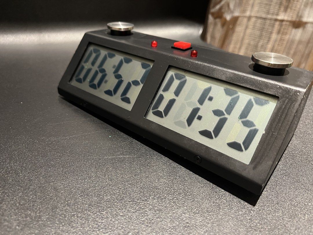 Digital Chess Clock Timer for Board Games (Category: Board Games & Puzzles) located in Manila. Submitted by mishimoto (Listing ID 1466966065, Image 1). Description: - Type: Digital chess clock - Condition: Fully functional, minor surface dust from storage - Features: Dual LCD screens, large metal push buttons, central red button, and indicator lights - Power: Battery-operated - Use: Standard tournament size, great for chess competitions or casual