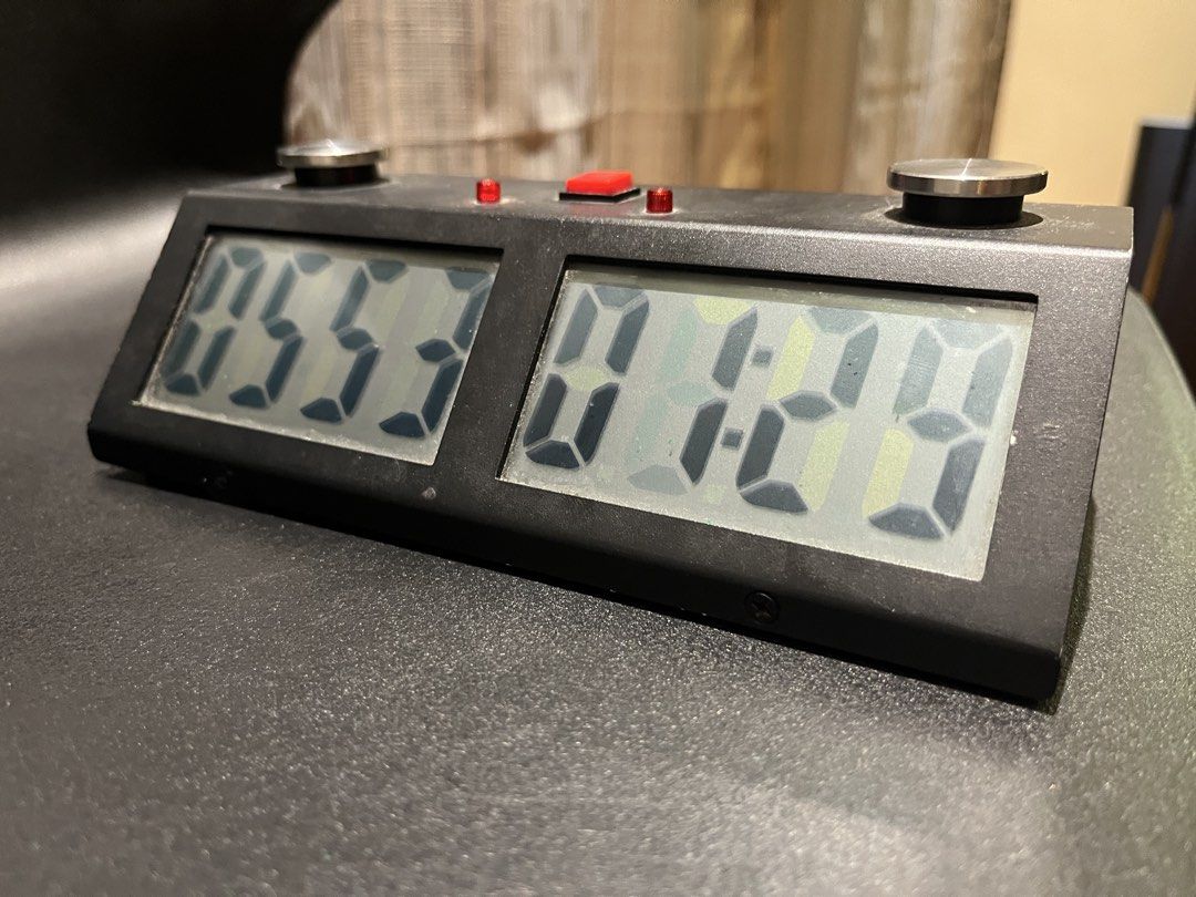 Digital Chess Clock Timer for Board Games (Category: Board Games & Puzzles) located in Manila. Submitted by mishimoto (Listing ID 1466966065, Image 2). Description: - Type: Digital chess clock - Condition: Fully functional, minor surface dust from storage - Features: Dual LCD screens, large metal push buttons, central red button, and indicator lights - Power: Battery-operated - Use: Standard tournament size, great for chess competitions or casual