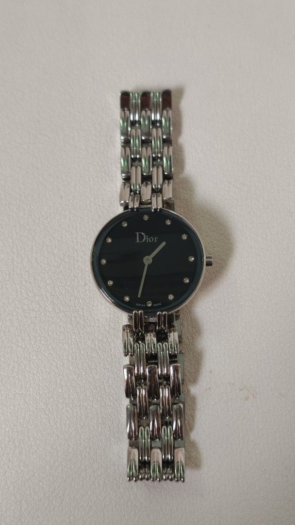 Dior Black Dial Silver Tone Ladies Watch (Category: Women's Watches) located in Mandaluyong City. Submitted by sirmeal (Listing ID 1466821307, Image 2). Description: Prelove but good as new unit only n ordinary watch box Christian Dior watch - Elegant black dial with silver hands and sparkling crystal markers - Silver-tone link bracelet with secure butterfly clasp closure - Signature CD logo engraved on the crown - Case back features official Chr
