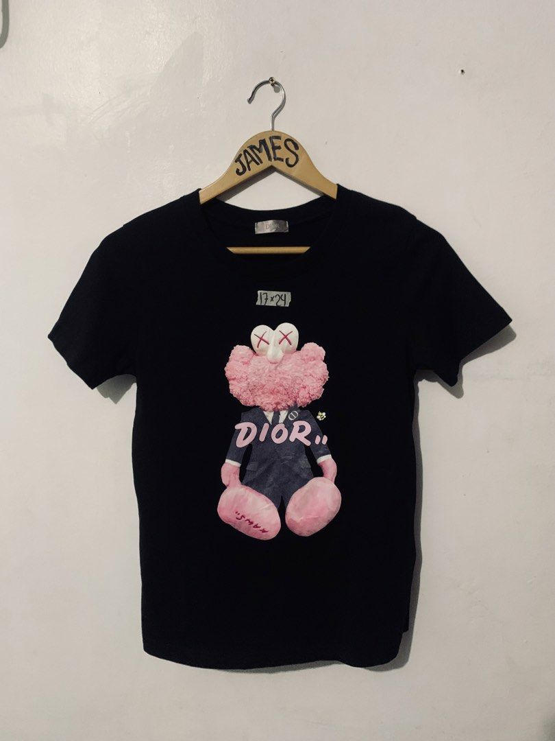 Dior x Kaws Black Pink Graphic Tee (Category: Tshirts & Polo Shirts ) located in Manila. Submitted by tanjames.14 (Listing ID 1466891497, Image 1). Description: - Brand: Dior - Design: Iconic pink Kaws character graphic on black tee - Size: Large (Tag says L, measures 17" x 24" flat) - Material: Premium cotton blend, Made in Italy - Style: Crewneck, short sleeve - Condition: Excellent, ready to wear - Mode of Payment: GCash, BPI, or Maya - Shippi