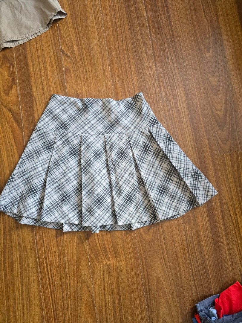 Divided by H&M Pleated Checkered Skirt (Category: Skirts) located in Manila. Submitted by mibellascloset (Listing ID 1466797230, Image 1). Description: take all for 500 - Brand: Divided by H&M - Design: Classic black and white plaid pattern - Style: Pleated, short length, schoolgirl aesthetic - Size: EUR 32 - Closure: Convenient side zipper - Material: Lightweight and easy to style - Condition: Wardrobe clear-out piece, perfect to pair with overs