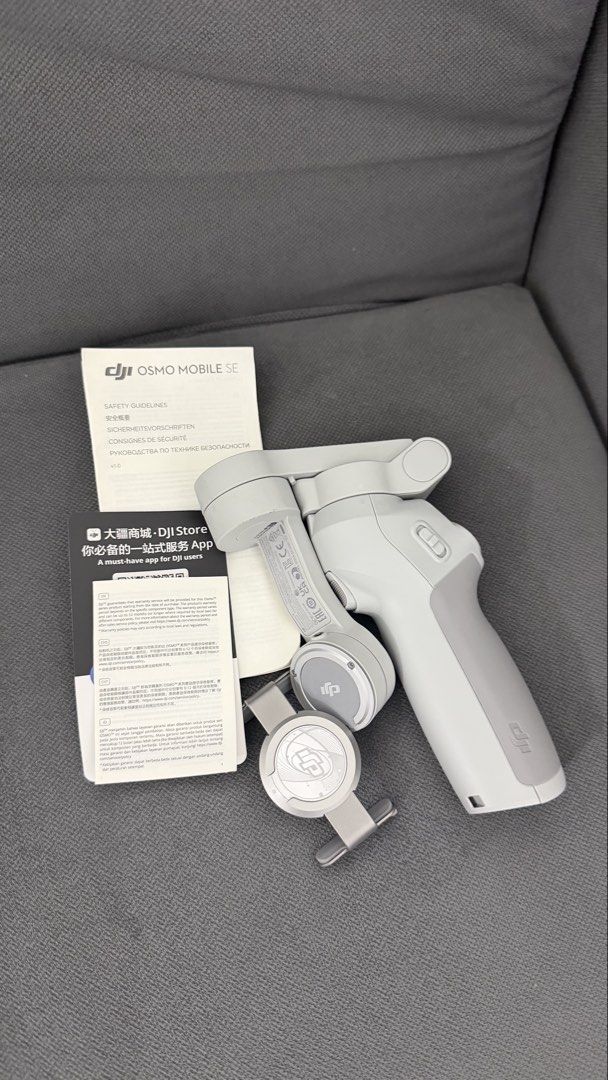 DJI Osmo Mobile SE Smartphone Stabilizer (Category: Gimbals & Stabilizers ) located in Makati City. Submitted by kawanderajan (Listing ID 1466788535, Image 1). Description: - Model: DJI Osmo Mobile SE (Light Grey) - Design: Foldable, highly portable for travel - Mounting: Quick-release magnetic phone clamp - Inclusions: Original storage pouch, safety guidelines, and setup manual - Condition: Fully intact, excellent working condition, perfect for 