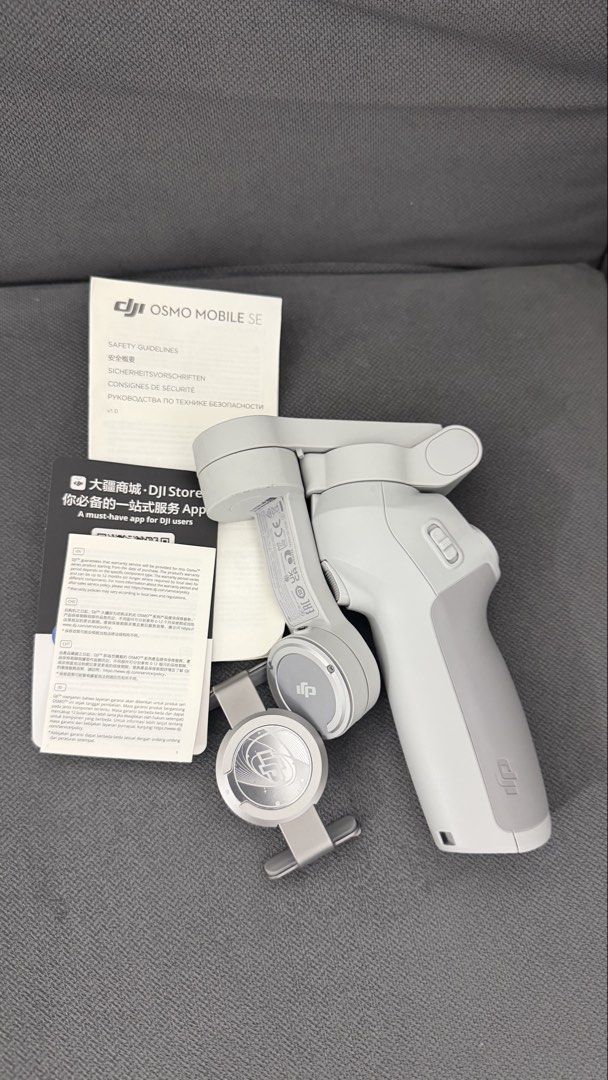 DJI Osmo Mobile SE Smartphone Stabilizer (Category: Gimbals & Stabilizers ) located in Makati City. Submitted by kawanderajan (Listing ID 1466788535, Image 2). Description: - Model: DJI Osmo Mobile SE (Light Grey) - Design: Foldable, highly portable for travel - Mounting: Quick-release magnetic phone clamp - Inclusions: Original storage pouch, safety guidelines, and setup manual - Condition: Fully intact, excellent working condition, perfect for 