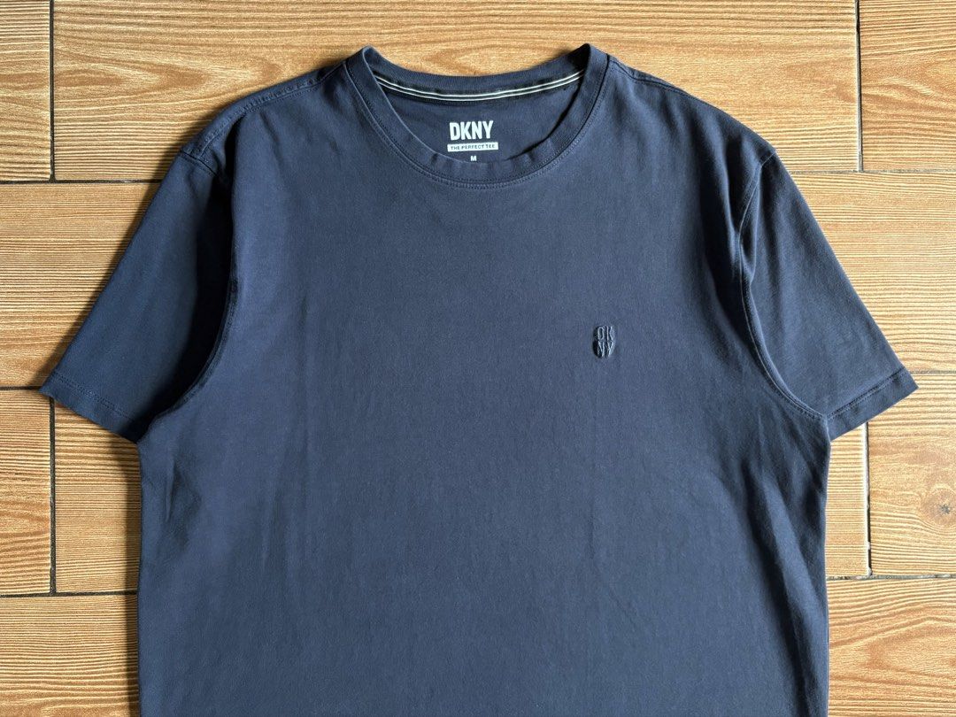 DKNY THE PERFECT TEE EMBROIDERED CHEST LOGO (Category: Shirts) located in Baras. Submitted by jnc__apparel (Listing ID 1466907969, Image 2). Description: 🏷️ DKNY THE PERFECT TEE EMBROIDERED CHEST LOGO 📌 Dimes: 26L x 20.5W 📌 Size: Medium on tag best fit XL for womens 📌 Condition: Excellent 📌 Color rate: 9.5/10 📌 Issue: None ✅ Washed and ready to wear.