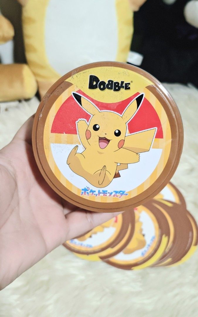 DOBBLE POKÉMON CARD GAME (Category: Other Merchandise) located in Manila. Submitted by yourfavoritethings7 (Listing ID 1466932976, Image 2). Description: circular card - 55 pcs Tin can cover - with tape marks.