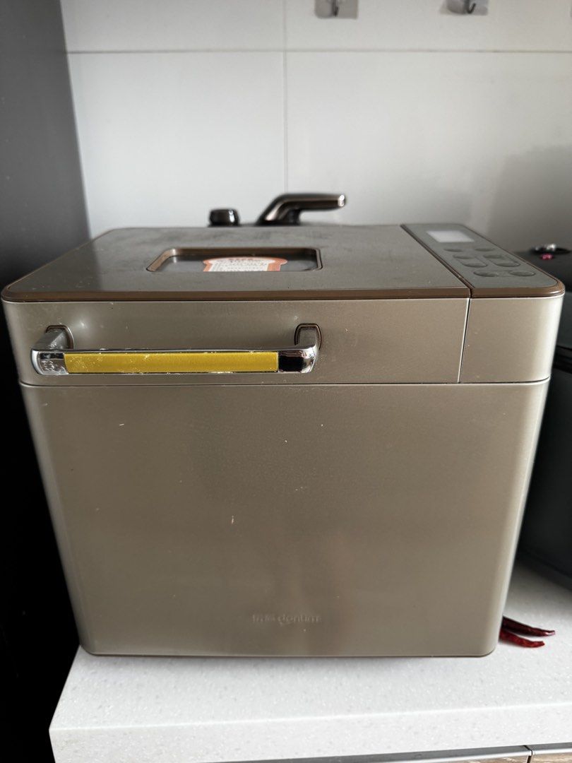 Donlim Automatic Bread Maker Machine (Category: Breadmakers) located in Singapore. Submitted by terry.pt (Listing ID 1466801960, Image 1). Description: - Elegant champagne gold automatic bread maker - Built-in recipe list with 25 programs (basic bread, dough, jam & more) - Convenient top viewing window and electronic control panel - Sleek metallic handle and clean body design - Perfect for effortless fresh bread baking at home.