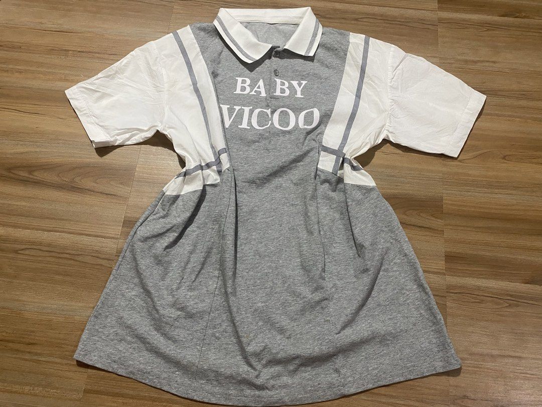 Dress L-XXL🤍 (Category: Dresses) located in Bulacan. Submitted by Spothings (Listing ID 1466937436, Image 1). Description: With two side pocket Length 33" - Brand: Baby Vicoo - Color: Grey and white - Material: Comfortable cotton blend - Design: Short sleeves, classic collar with button placket - Details: White contrast panels, striped ribbon trim, and bold BABY VICOO chest print - Fit/Style: Casual dress, perfect for daily wear.