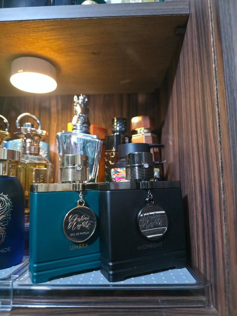 Dubai Nights Midnight & Umbra Eau De Parfum Set (Category: Fragrance & Deodorants) located in Imus. Submitted by engr.sprsnts (Listing ID 1466963475, Image 1). Description: - Product: Dubai Nights Fragrance Set (2 bottles) - Variants: Midnight (Black bottle) and Umbra (Teal bottle) 2299 EACH COMPLETE WITH BOX - Concentration: Eau De Parfum (EDP) - Design: Features hanging round metal medallions on the front - Packaging: Comes in matching rectangu