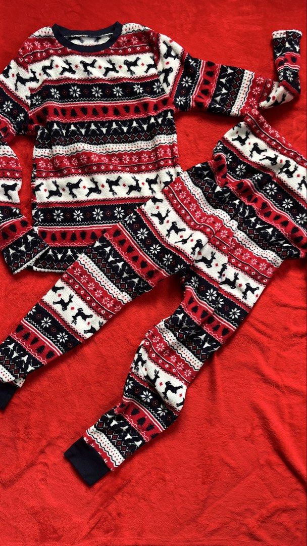 Dunnes Stores Christmas Reindeer Pyjama Set (Category: Undergarments & Loungewear) located in Manila. Submitted by tineemall (Listing ID 1466784607, Image 1). Description: - Brand: Dunnes Stores - Design: Festive navy, white, and red Nordic reindeer print - Material: Super warm and cozy fuzzy fleece - Set includes: Matching long sleeve top and trousers - Sizing: Top fits chest 33-34 inches (84-86 cm), Bottoms fit waist 26 inches (66 cm) - Conditi