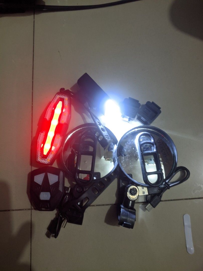 E-Bike assorted accessories (Category: Bicycles) located in Cabuyao City. Submitted by rho.oh.decluts (Listing ID 1466824057, Image 1). Description: - Bundle of essential bicycle gear for commuting and casual riding - Includes 2 rearview mirrors on sturdy metal bars - Features an adjustable phone holder clamp - Comes with rechargeable LED lights (bright white headlight and multi-mode red taillight) - Everything pictured is included in the package