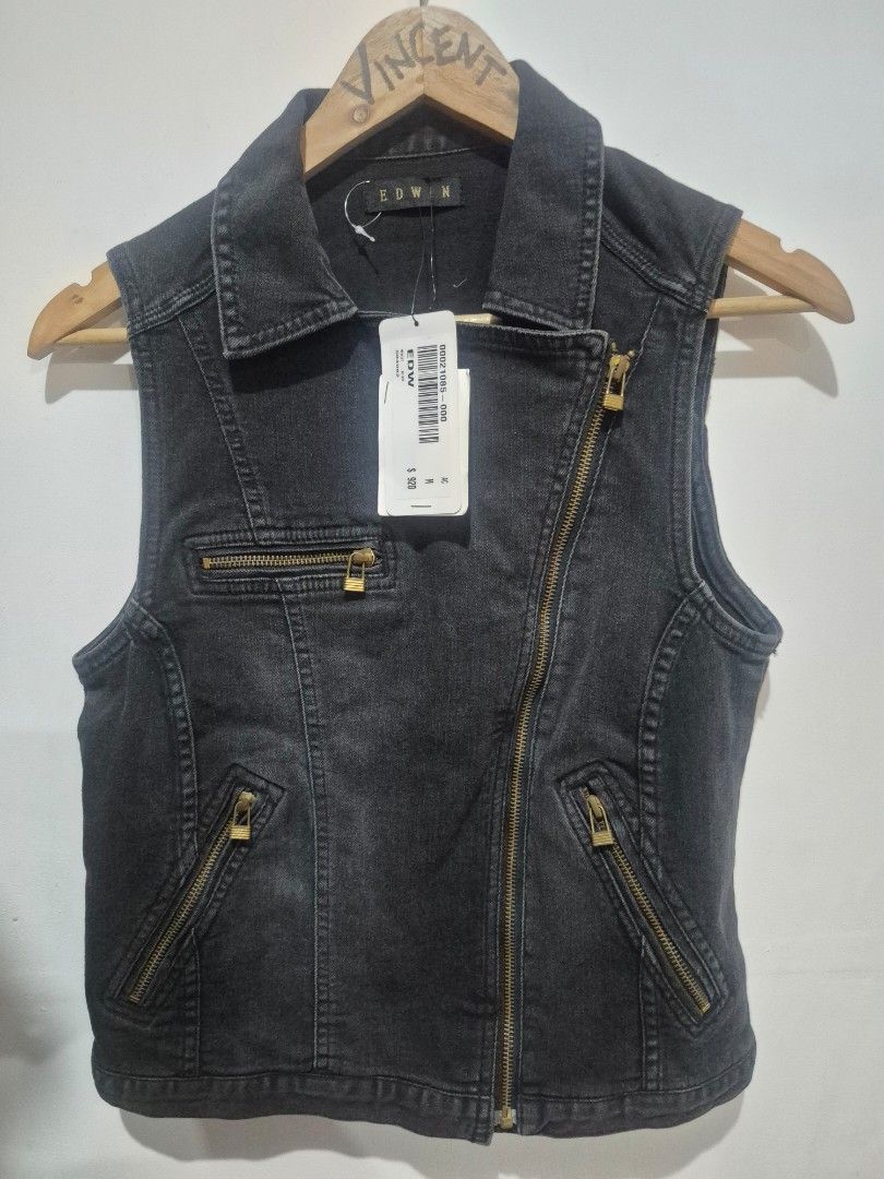EDWIN Black Denim Biker Vest (Category: Vests) located in Bulacan. Submitted by vince4593 (Listing ID 1466879719, Image 1). Description: - Brand: EDWIN - Size: M - Color: Washed black - Material: Comfortable cotton blend - Design: Heavy zip detailing with an asymmetrical front zipper and multiple zippered pockets - Style: Collared neckline, sleeveless cut - Condition: Brand new with original store price tag still attached.