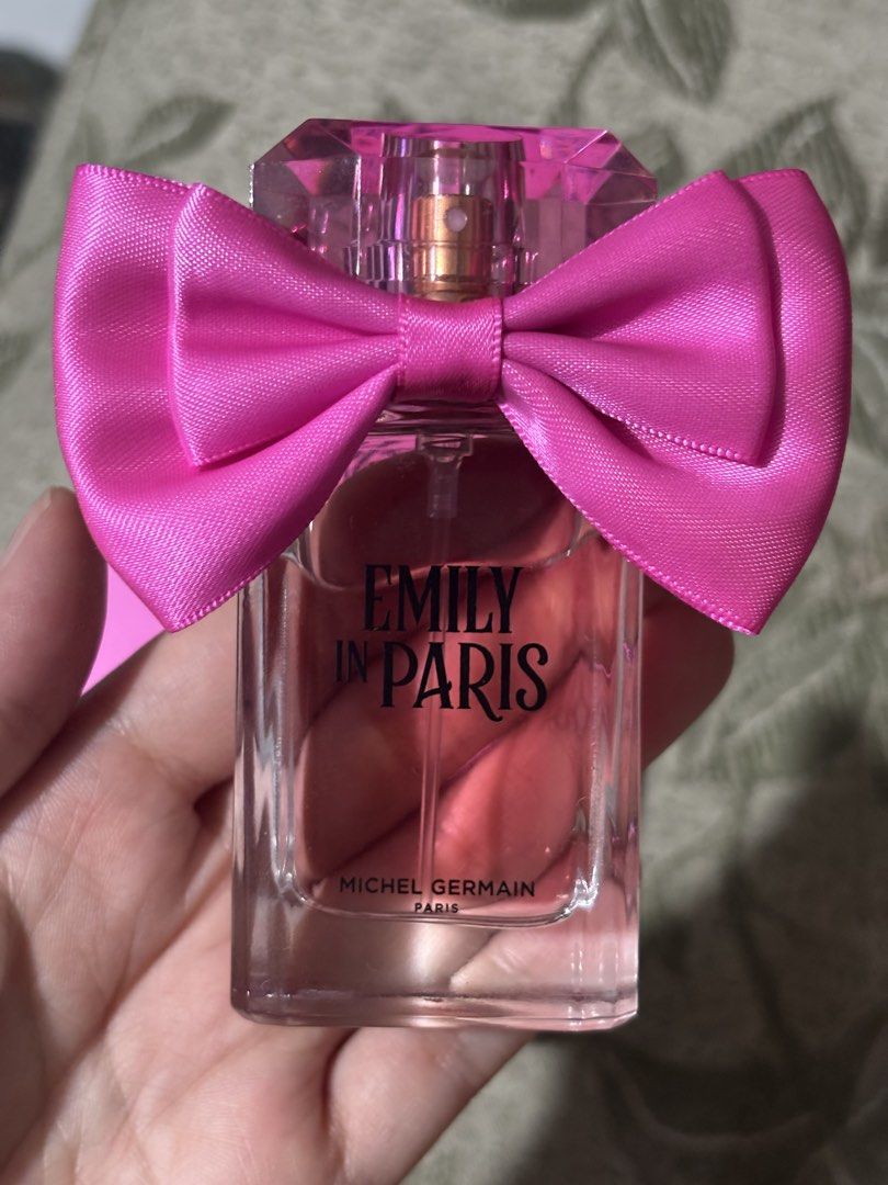 Emily in Paris Michel Germain Eau de Parfum 30ml (Category: Fragrance & Deodorants) located in Manila. Submitted by pochieee2916 (Listing ID 1466893924, Image 2). Description: - Item: Michel Germain Emily in Paris Eau de Parfum - Size: 30 ml / 1.0 fl. oz. - Condition: Brand new, unused (box opened for photos only) - Packaging: Includes original vibrant pink and plaid box with cute neck ribbon - Authentic and ready to ship.
