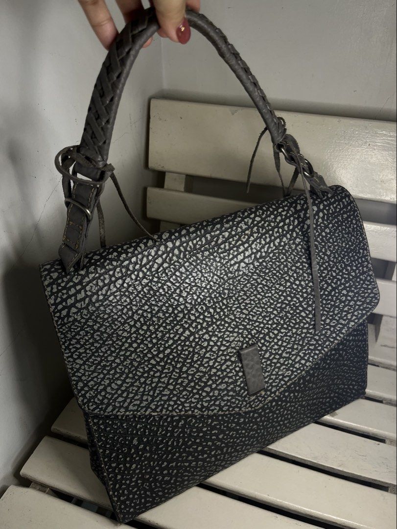 Ensoen Grey Textured Leather Shoulder Bag with Braided Strap (Category: Shoulder Bags) located in Iloilo. Submitted by selectionsbykat (Listing ID 1466798877, Image 2). Description: - Stylish grey and black textured leather shoulder bag - Flap closure with a secure magnetic snap tab - Trendy braided top handle with tassel fringe accents and silver-tone hardware - Extra storage with a side zipper pocket and back exterior zipper pocket - Structured