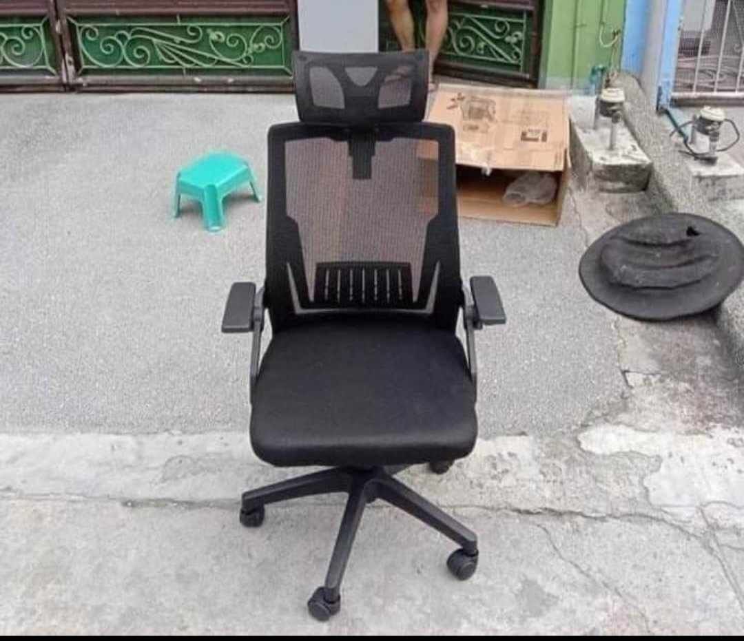 Ergonomic Mesh Office Chair with Headrest (Category: Office Furniture & Fixtures) located in Manila. Submitted by jamfrimzy089458 (Listing ID 1466794564, Image 3). Description: - Ergonomic office chair designed for work from home or long hours at the desk - Breathable mesh back and adjustable headrest for superior comfort - Comfortable padded seat cushion and sturdy five-star base with rolling casters - Convenient flip-up armrests that easily sli