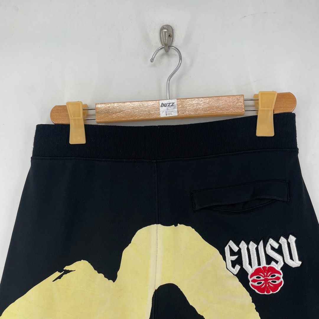 Evisu Big Logo Daicock Sweat Shorts (Category: Shorts) located in Manila. Submitted by buzz.garments (Listing ID 1466932198, Image 2). Description: Size: Medium on tag Dimensions(inches) - Waist/Width: 31”-38” (Strechable) - Hip: 20” - Front Rise: 14” - Thigh: 11” - Inseam: 8” - Outseam/Length : 21” - Leg Opening: 10 - color may vary due to lighting. please manage your expectations-minimal and unseen flaws must be considered..