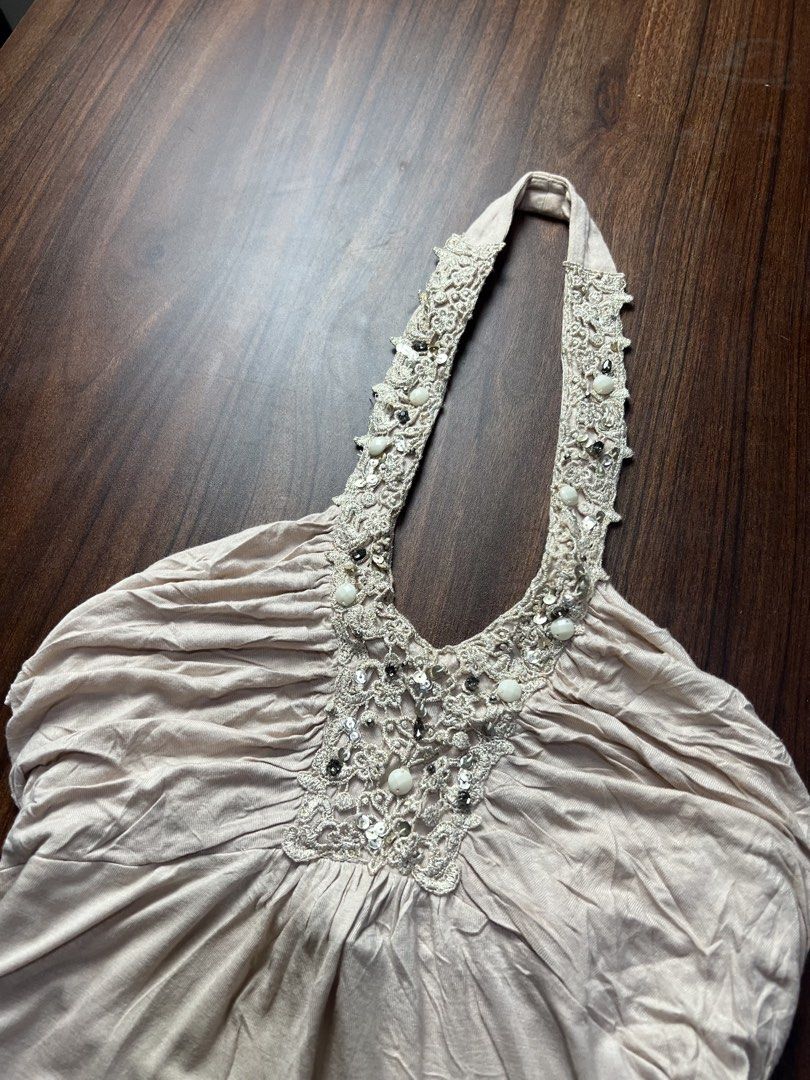 Express Beige Beaded Halter Top Size S (Category: Sleeveless) located in Oroquieta. Submitted by zjstg (Listing ID 1466870982, Image 2). Description: - Brand/Style: Express beige halter top - Size: Small - Material: Soft knit fabric with pleated bodice detailing - Accents: Beaded and sequined lace embroidery on neckline and straps - Fit: Backless with a flowy, relaxed silhouette - Origin: Made in the Philippines - Ideal for: Summer outings or cas