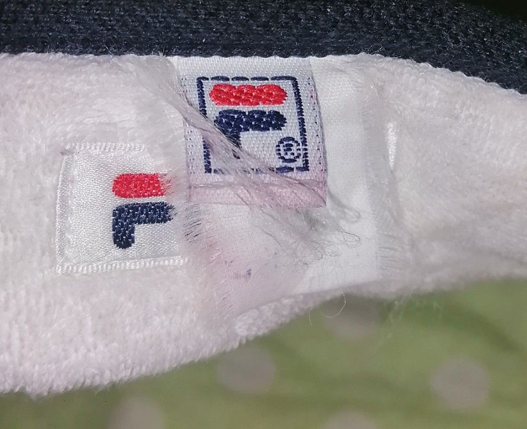 Fila Black Sport Visor Cap (Category: Caps & Hats) located in Quezon City. Submitted by rolenalma (Listing ID 1466927766, Image 3). Description: - Color: Classic Navy blue - Brand: Vintage Fila with embroidered front logo - Design: Structured brim with textured fabric finish - Comfort: Interior white towelling sweatband lining - Fit: Adjustable back strap with white plastic sliders - Ideal for: Outdoor wear, sports, and tennis matches.
