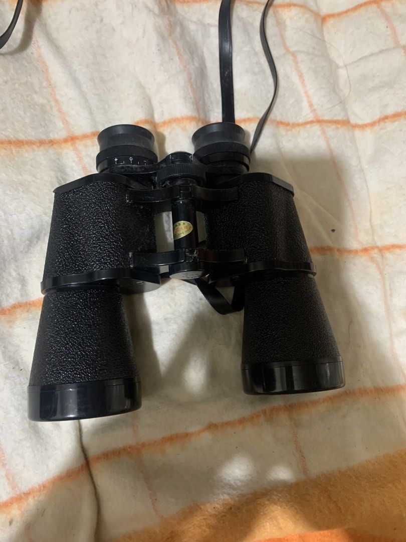 Fokus 7x50 Field 7.1 Binoculars with Case (Category: Hiking & Camping) located in Malolos. Submitted by rubyche88 (Listing ID 1466889955, Image 2). Description: - Brand/Model: Fokus 7x50 binoculars - Field of view: 124m at 1000m - Design: Black textured body with adjustable eyepieces and attached neck strap - Includes: Matching hard storage case with snap button closure - Condition: Optics and body show typical signs of handling and dust - Best f
