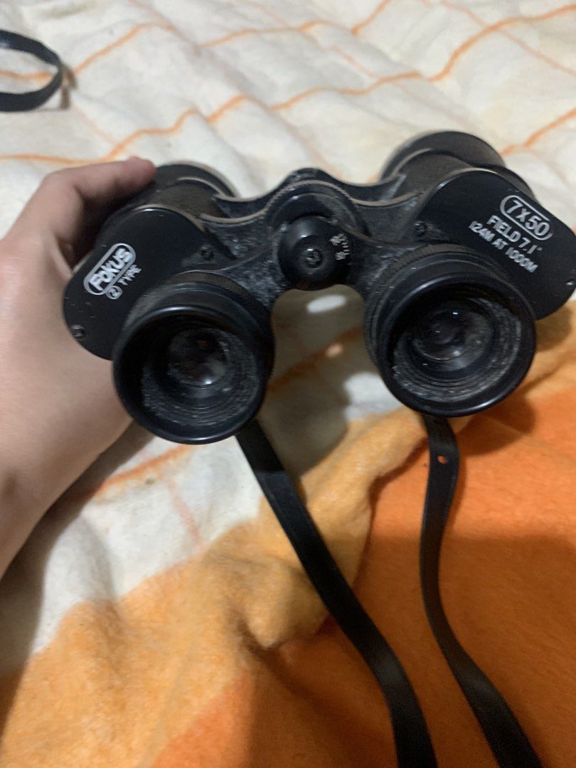 Fokus 7x50 Field 7.1 Binoculars with Case (Category: Hiking & Camping) located in Malolos. Submitted by rubyche88 (Listing ID 1466889955, Image 1). Description: - Brand/Model: Fokus 7x50 binoculars - Field of view: 124m at 1000m - Design: Black textured body with adjustable eyepieces and attached neck strap - Includes: Matching hard storage case with snap button closure - Condition: Optics and body show typical signs of handling and dust - Best f