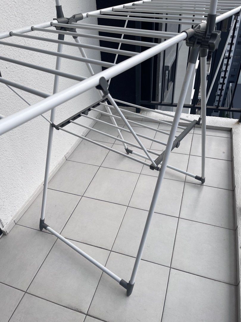 Foldable Drying Rack (Category: Clothes Drying Rack) located in Puchong. Submitted by amalhalim (Listing ID 1466777074, Image 3). Description: - Type: Foldable Clothes Drying Rack - Color: White and Grey - Design: Space-saving collapsible design with multiple drying rails, ideal for condo/apartment balconies - Condition: Good, sturdy, and fully functional - Storage: Easy to fold flat when not in use - Bought for RM 130+, selling cheaper - Only av