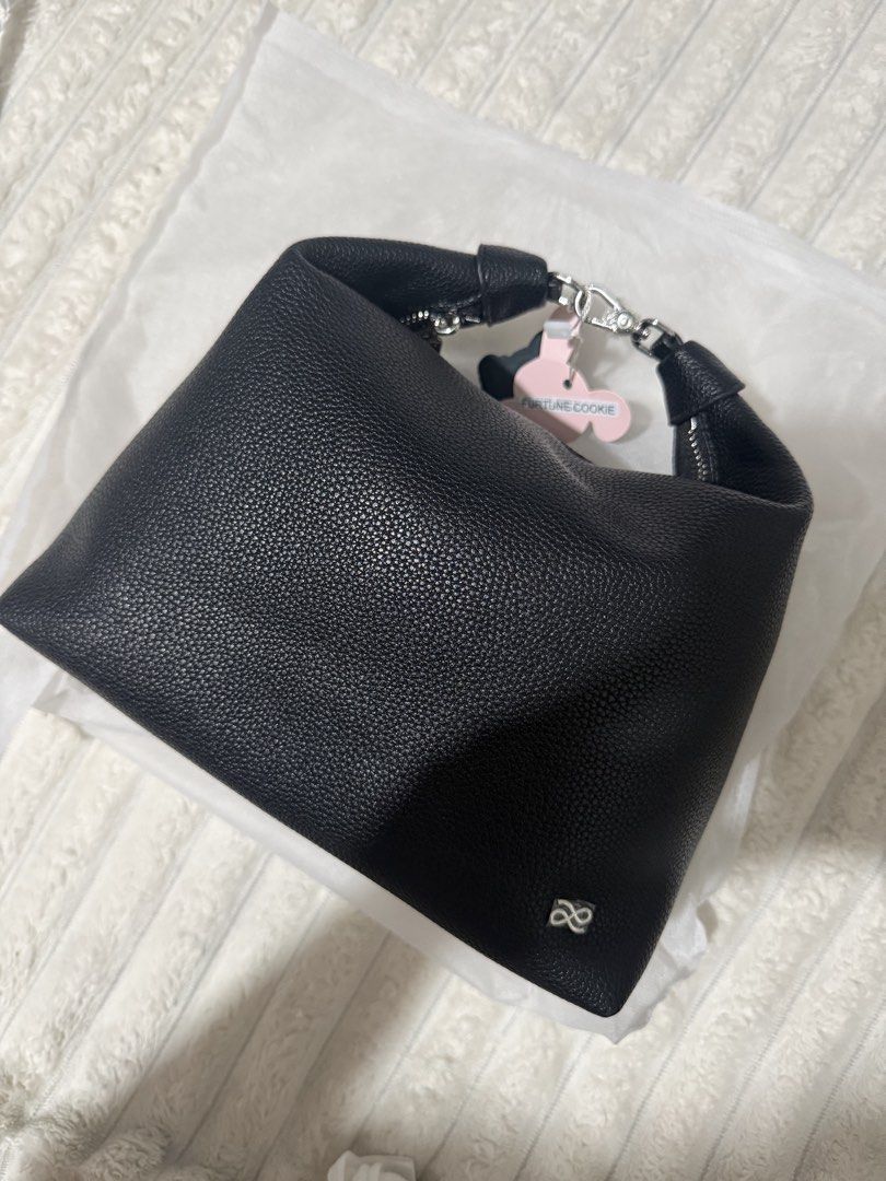 Fortune Cookie Black Leather Hobo Bag (Category: Shoulder Bags) located in Las Pinas. Submitted by yourboki.2026 (Listing ID 1466807622, Image 2). Description: - Brand: Fortune Cookie hobo bag - Material: Black pebbled leather with silver-tone hardware and front logo emblem - Closure: Secure zip-top closure with tag still attached to the zipper pull - Interior: Clean light beige fabric lining - Straps: Includes a detachable shoulder strap (still 