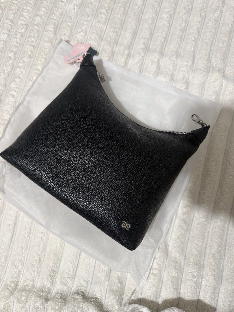 Fortune Cookie Black Leather Hobo Bag (Category: Shoulder Bags) located in Las Pinas. Submitted by yourboki.2026 (Listing ID 1466807622, Image 1). Description: - Brand: Fortune Cookie hobo bag - Material: Black pebbled leather with silver-tone hardware and front logo emblem - Closure: Secure zip-top closure with tag still attached to the zipper pull - Interior: Clean light beige fabric lining - Straps: Includes a detachable shoulder strap (still 