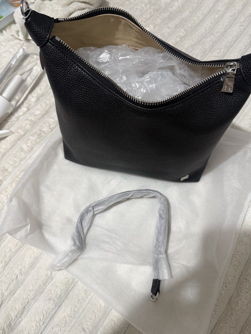 Fortune Cookie Black Leather Hobo Bag (Category: Shoulder Bags) located in Las Pinas. Submitted by yourboki.2026 (Listing ID 1466807622, Image 3). Description: - Brand: Fortune Cookie hobo bag - Material: Black pebbled leather with silver-tone hardware and front logo emblem - Closure: Secure zip-top closure with tag still attached to the zipper pull - Interior: Clean light beige fabric lining - Straps: Includes a detachable shoulder strap (still 