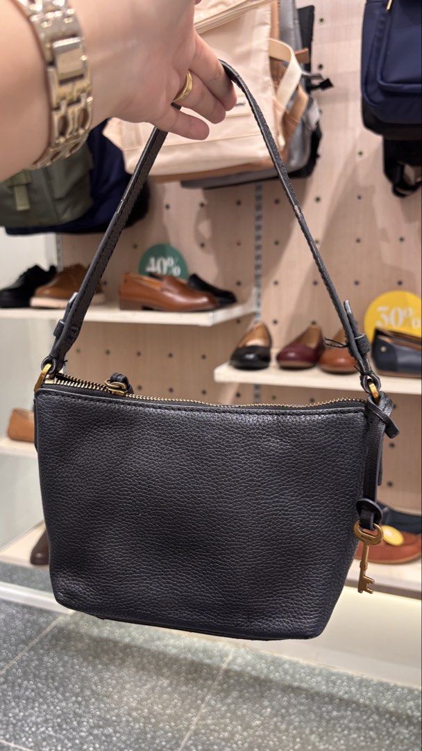 Fossil Black Leather Shoulder Bag (Category: Shoulder Bags) located in Antipolo. Submitted by annesmarket (Listing ID 1466847333, Image 3). Description: - Brand: Fossil - Material: Genuine black pebbled leather - Hardware: Elegant gold-tone accents and zipper closure - Strap: Single adjustable black strap with side buckles - Details: Signature Fossil key charm and gold foil logo stamped near the bottom front - Condition: Excellent, well-maintaine