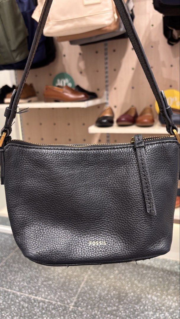 Fossil Black Leather Shoulder Bag (Category: Shoulder Bags) located in Antipolo. Submitted by annesmarket (Listing ID 1466847333, Image 2). Description: - Brand: Fossil - Material: Genuine black pebbled leather - Hardware: Elegant gold-tone accents and zipper closure - Strap: Single adjustable black strap with side buckles - Details: Signature Fossil key charm and gold foil logo stamped near the bottom front - Condition: Excellent, well-maintaine
