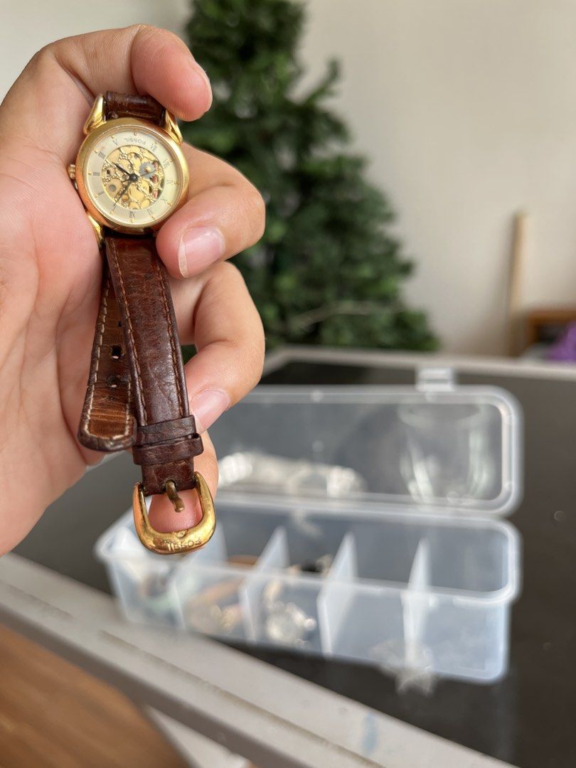 Fossil Gold-Tone Skeleton Dial Leather Strap Watch (Category: Women's Watches) located in Manila. Submitted by gelvintage (Listing ID 1466856025, Image 2). Description: - Brand: Fossil - Design: Gold-tone case with a stunning skeleton dial - Dial: Cream face with classic Roman numeral markers - Strap: Genuine brown leather with secure buckle closure - Case Back: Durable stainless steel - Condition: Shows normal, gentle signs of wear on the leathe