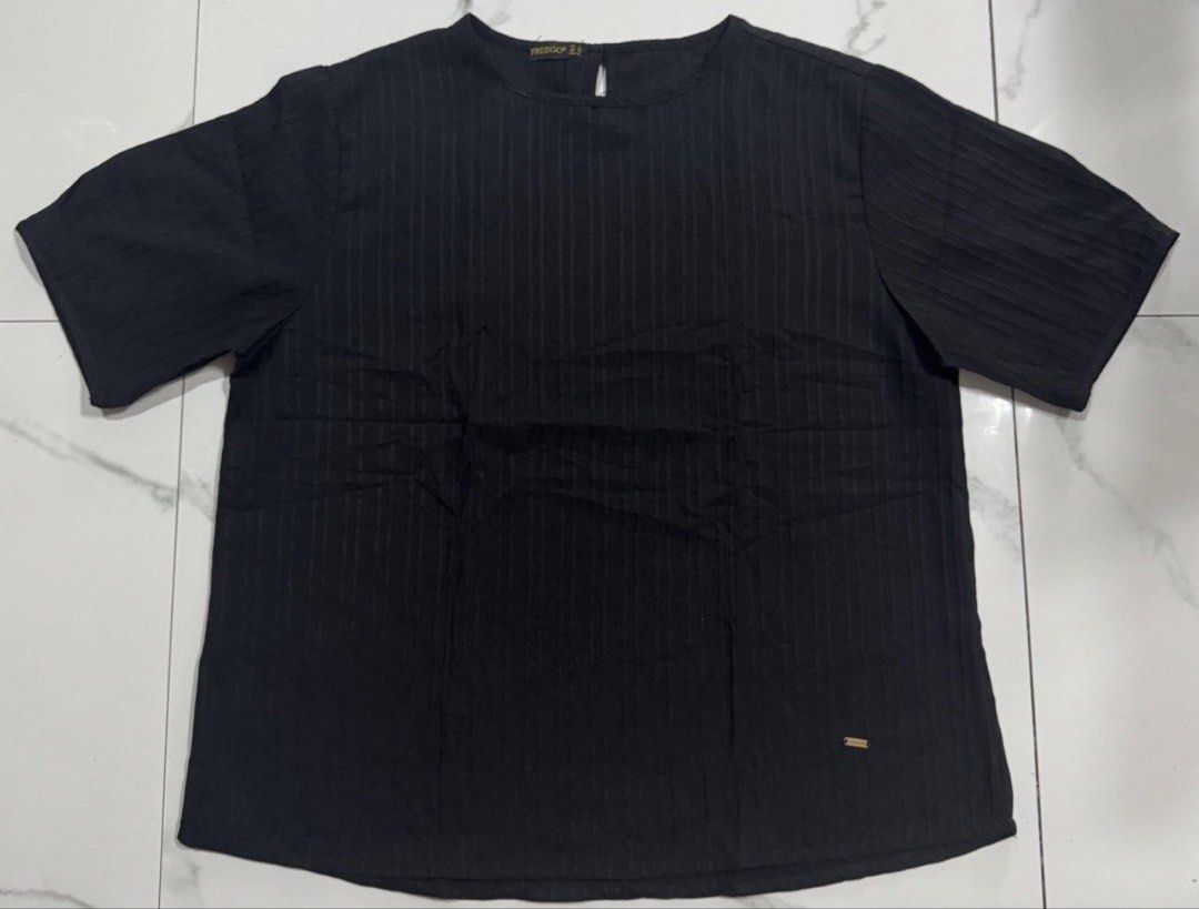 FREEGO Black Textured Short Sleeve Blouse (Category: Blouses) located in Pasay City. Submitted by szepter (Listing ID 1466793330, Image 1). Description: - Brand: FREEGO - Color: Neutral black - Style: Short-sleeve top with textured striped fabric, round neckline, and back keyhole button closure - Fit: Regular fit, straight hemline - Measurements (laid flat): Pit-to-pit ~25 inches, Length ~24 inches - Condition: Great everyday basic - Versatility: