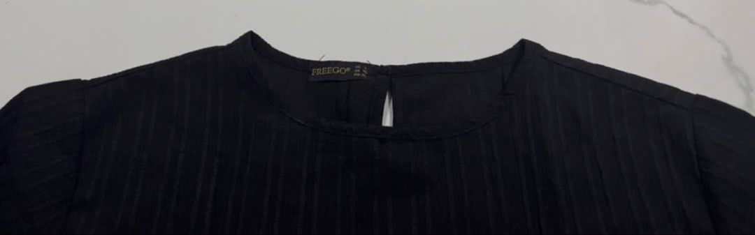 FREEGO Black Textured Short Sleeve Blouse (Category: Blouses) located in Pasay City. Submitted by szepter (Listing ID 1466793330, Image 3). Description: - Brand: FREEGO - Color: Neutral black - Style: Short-sleeve top with textured striped fabric, round neckline, and back keyhole button closure - Fit: Regular fit, straight hemline - Measurements (laid flat): Pit-to-pit ~25 inches, Length ~24 inches - Condition: Great everyday basic - Versatility: