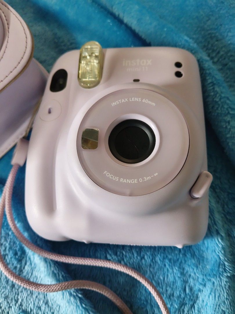 Fujifilm Instax Mini 11 Pastel Purple with Case (Category: Cameras) located in Manila. Submitted by artsylove24 (Listing ID 1466797321, Image 2). Description: - Model: Pastel purple Fujifilm instant camera - Condition: Tested and fully working (lens and flash checked) - Included: Matching leatherette case and wrist strap - Power: AA batteries already loaded inside - Perfect for: Parties, trips, and capturing memories.