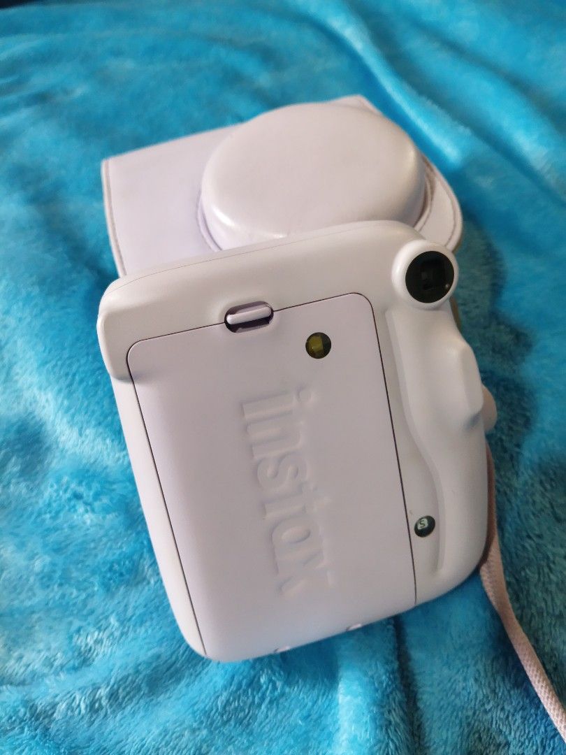 Fujifilm Instax Mini 11 Pastel Purple with Case (Category: Cameras) located in Manila. Submitted by artsylove24 (Listing ID 1466797321, Image 3). Description: - Model: Pastel purple Fujifilm instant camera - Condition: Tested and fully working (lens and flash checked) - Included: Matching leatherette case and wrist strap - Power: AA batteries already loaded inside - Perfect for: Parties, trips, and capturing memories.